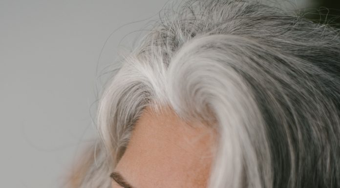 a woman with grey hair looking over her shoulder