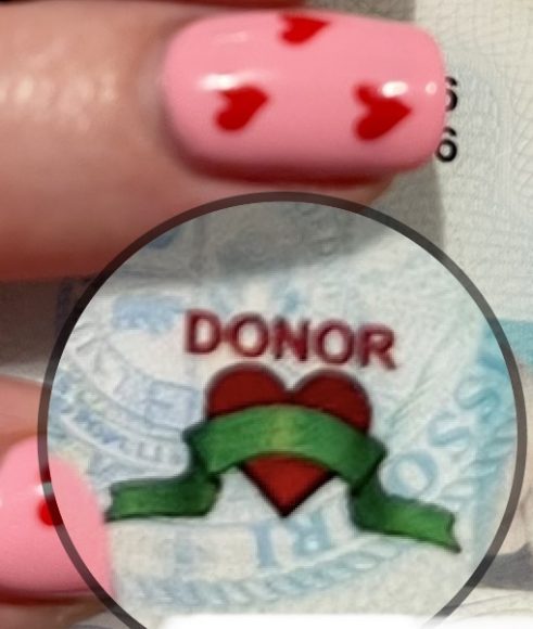 a heart with a banner over it with the word, “Donor” over it as is displayed on the Missouri Drivers license when you designate yourself as a potential organ donor