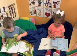kindergarten kids reading in a reading nook at Kiddie Academy in St. Louis