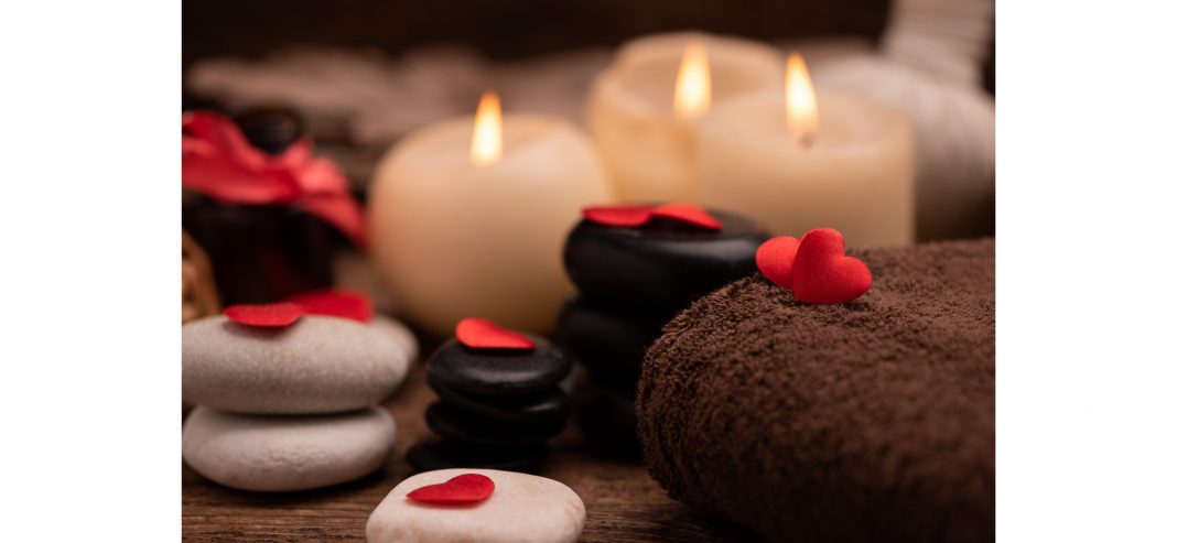 candles, stones, and a towel for a Valentine’s massage