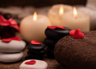 candles, stones, and a towel for a Valentine’s massage