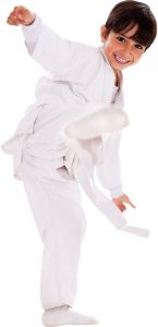 a boy in a white go with a white belt doing a karate kick