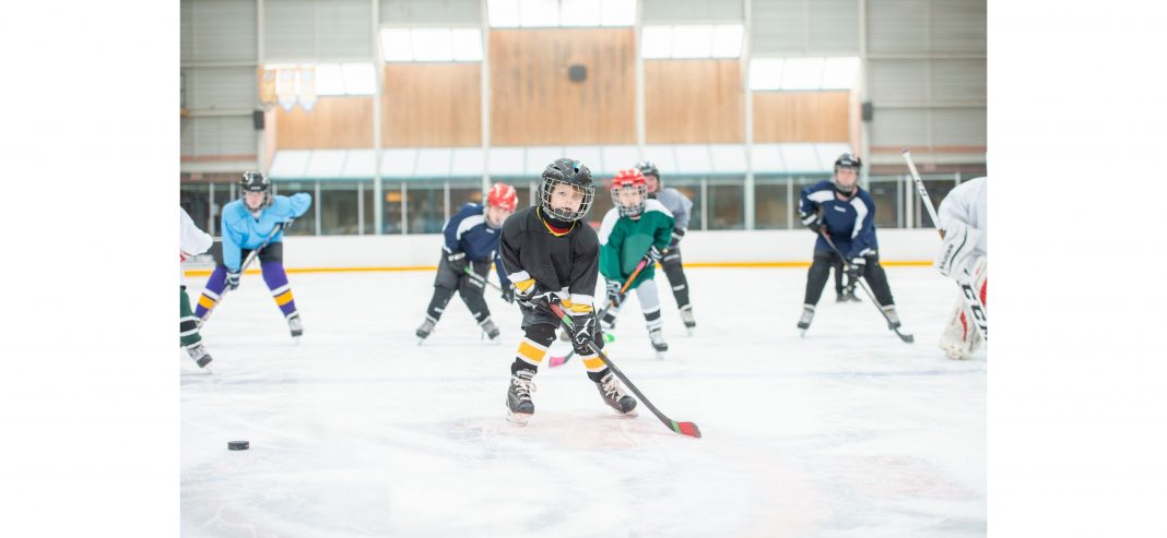 kids on the ice playing hockey