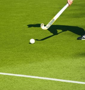 a field hockey stick and ball on a field
