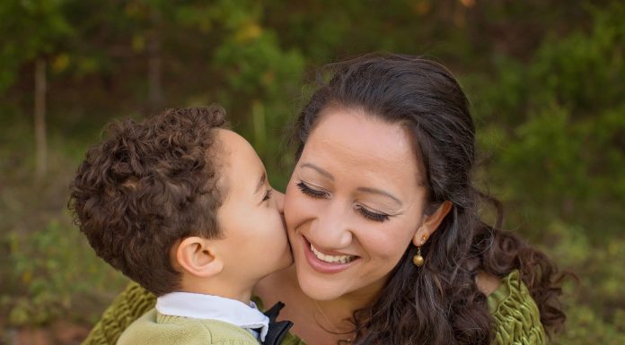 a little boy kissing his mom’s cheek