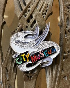 a silver dragon sign that says City Museum