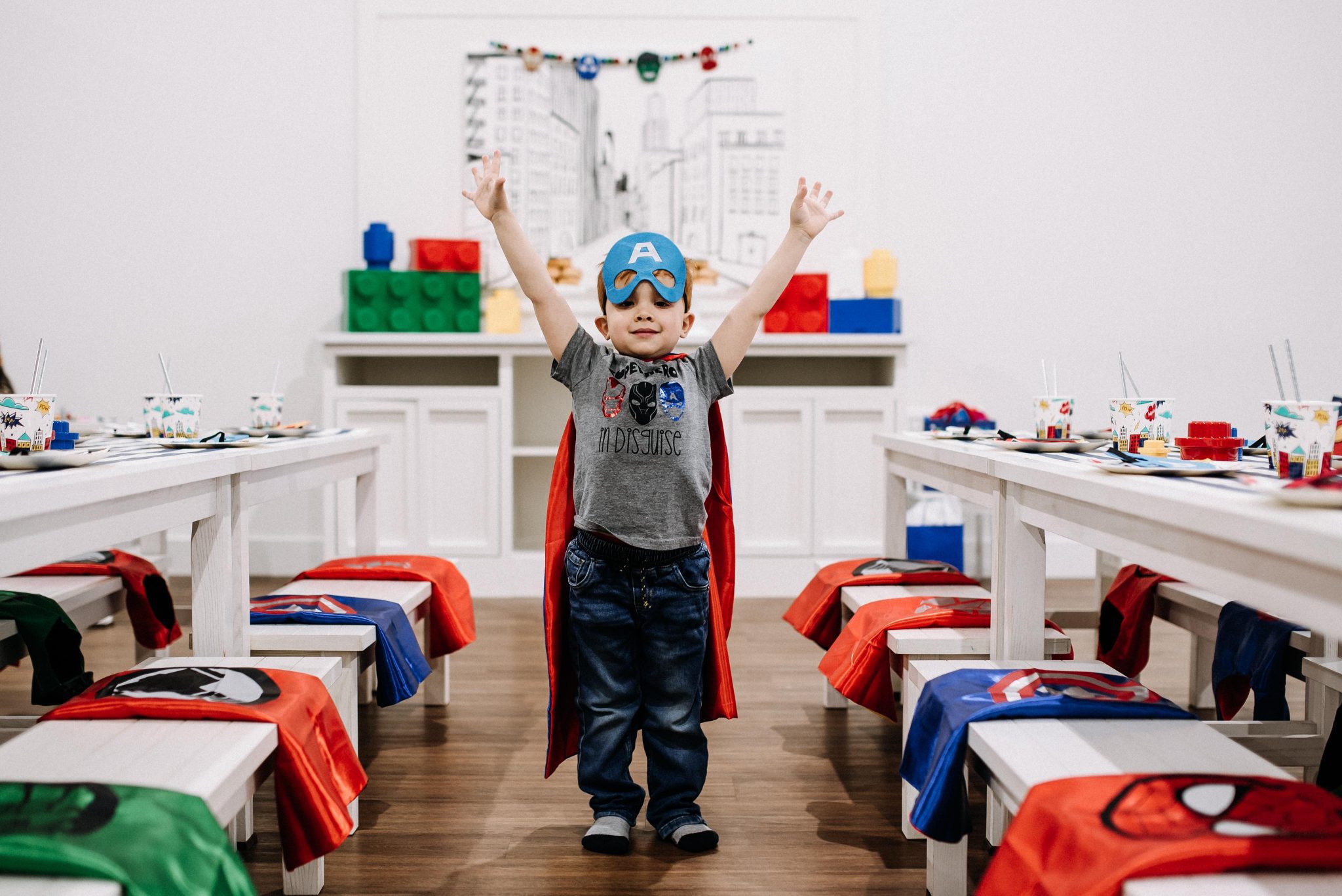 a child dressed as a superhero at a Play Street Museum birthday party in St. Louis