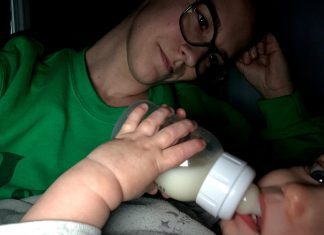 a mom staring at her baby as he drinks from a bottle