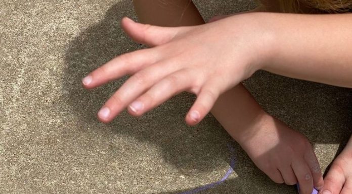 a summer science activity as a child looks at the shadow of their hand
