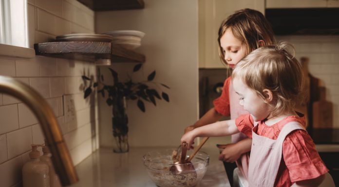 baking with toddlers as two toddlers work at the kitchen counter