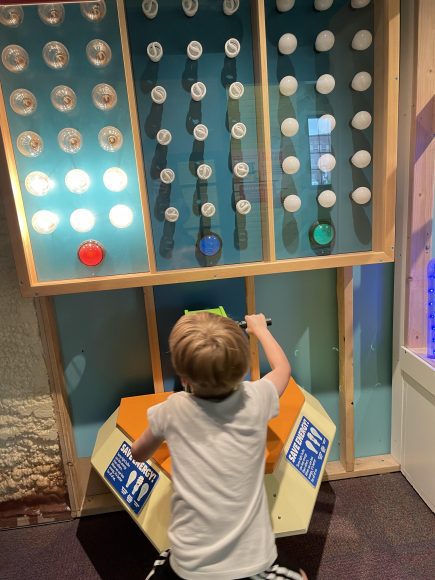 Josh using an arm bike to power a wall of light bulbs at a kids museum in Springfield, IL the home of Abraham Lincoln.