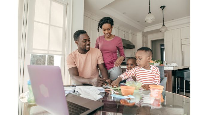 a family gathered around the kitchen table as a representation of the balance of family rhythm