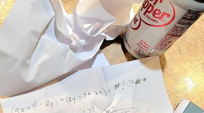a crumpled paper with math equations on it next to a pencil, calculator, and can of diet soda representing the nightmares of math