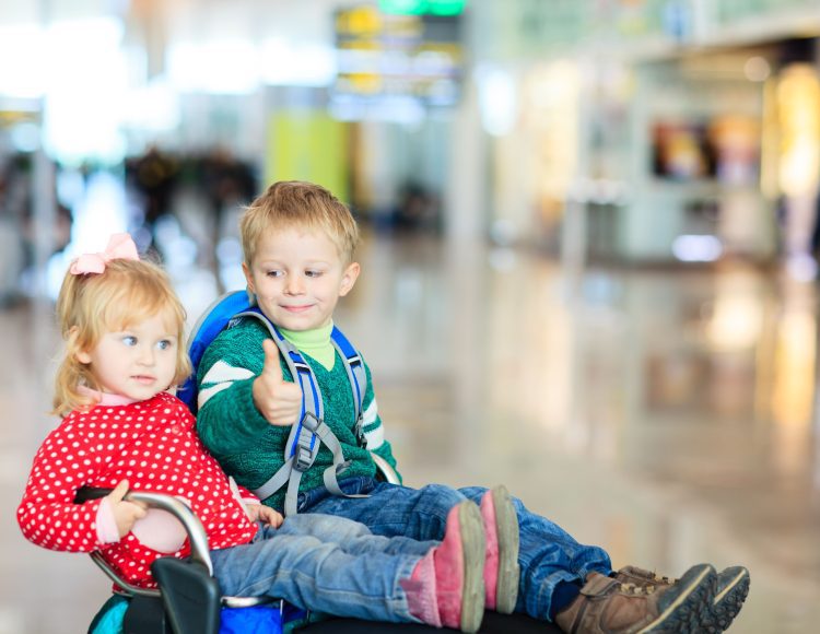 kids sitting at an airport