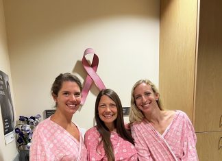 three women in pink hospital gowns as they get mammograms during breast cancer awareness month