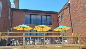 a patio with three umbrellas at Maeva’s Coffee in Alton, IL