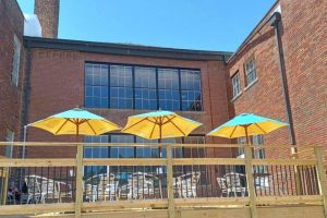 a patio with three umbrellas at Maeva’s Coffee in Alton, IL