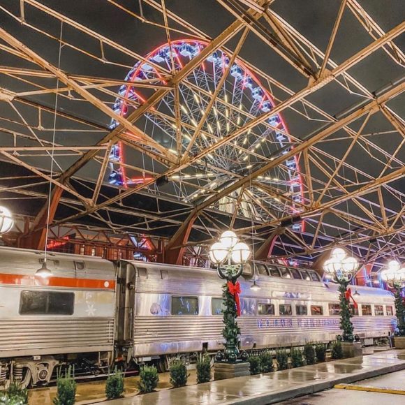 train at Union Station in St. Louis decked out for Polar Express while the Ferris wheel glows in the background
