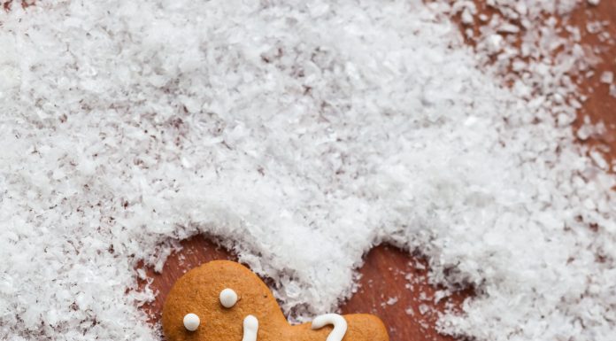 a gingerbread man making a snow angel in sugar