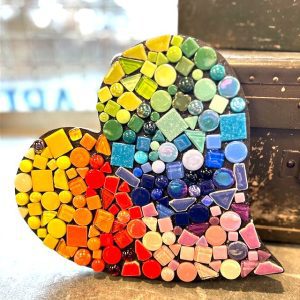 a heart decorated with rainbow colored mosaic tiles