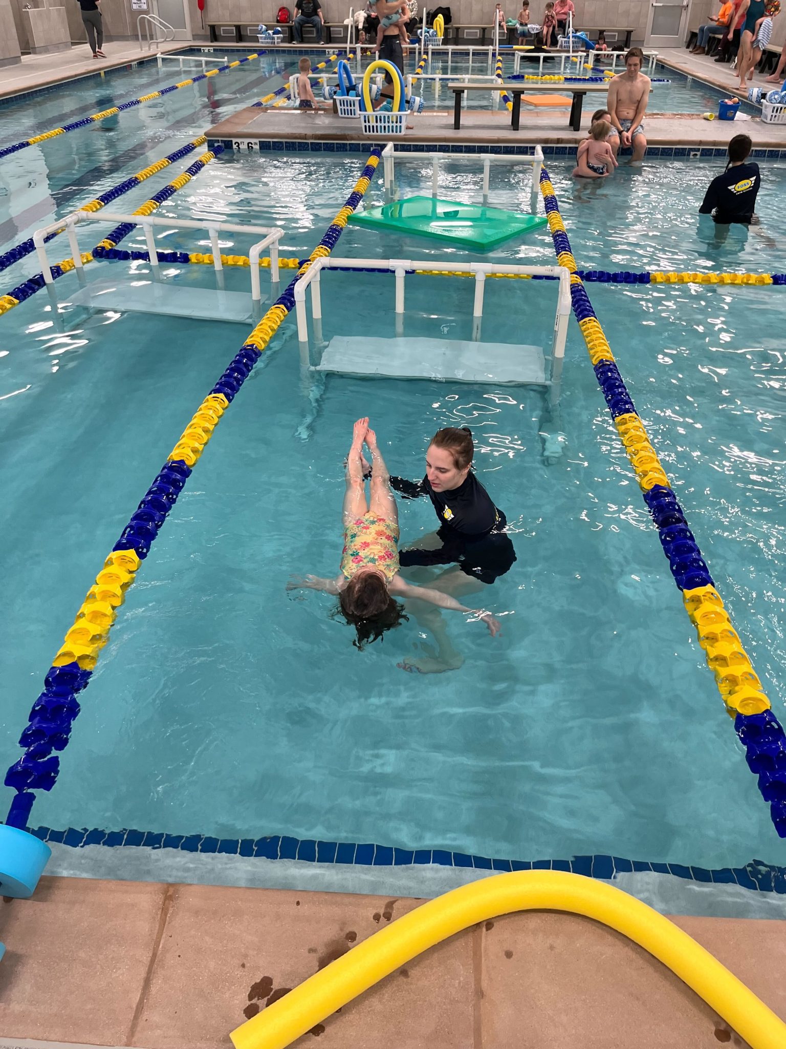a swim instructor in the pool with a student