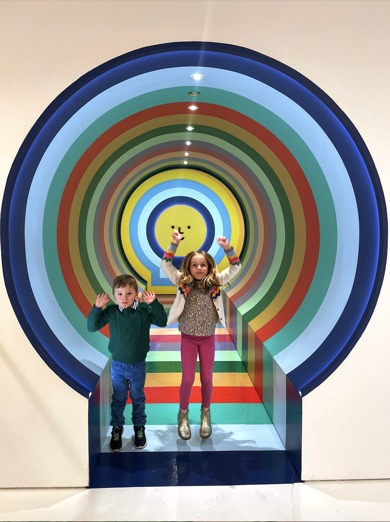 a boy and a girl in front of an exhibit at The Color Factory in Chicago