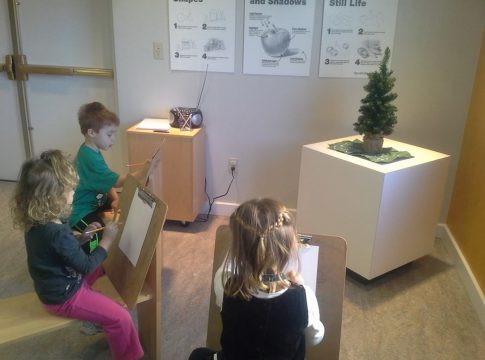 toddlers sketching a tree in the art studio at the Magic House in Kirkwood, MO