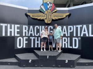 Family standing on top of the winners podium at the Indianapolis Motor Speedway