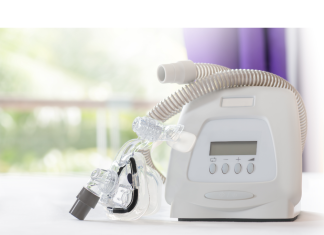 a CPAP machine sitting on a tabletop to help with sleep apnea