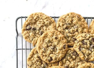a cooling rack filled with oatmeal cookie on a white countertop