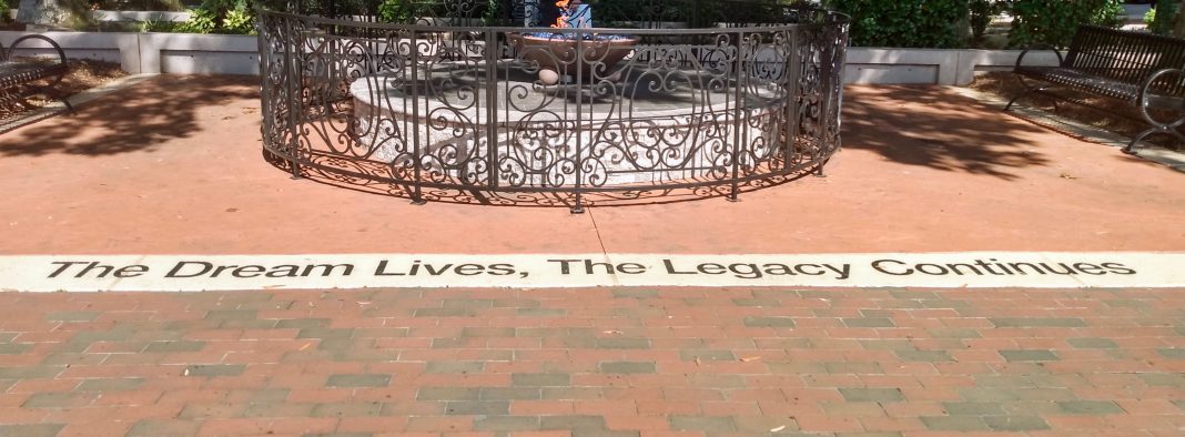 Quote on the ground in front of the eternal flame for Martin Luther King, Jr, "The Dream Lives. The Legacy Continues."