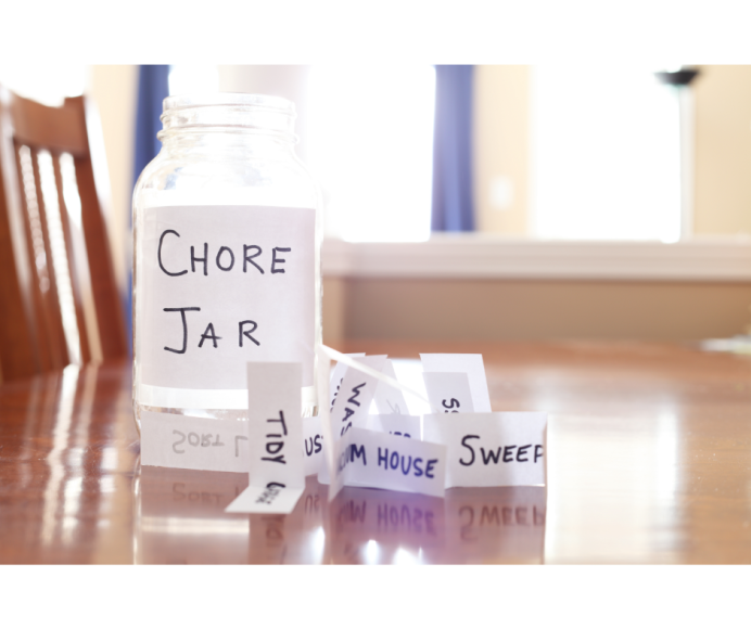 a chore jar on a table with chores written on slips of paper scattered on the tabletop