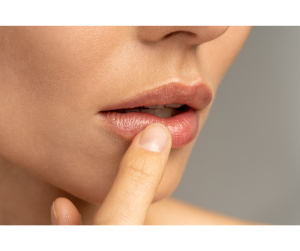a woman putting moisturizer on her lips 
