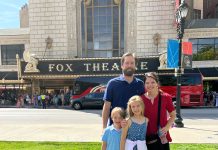 a mom and dad with their son and daughter, posing in front of the Fabulous Fox Theatre in St. Louis