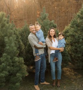 a family photo in front of trees