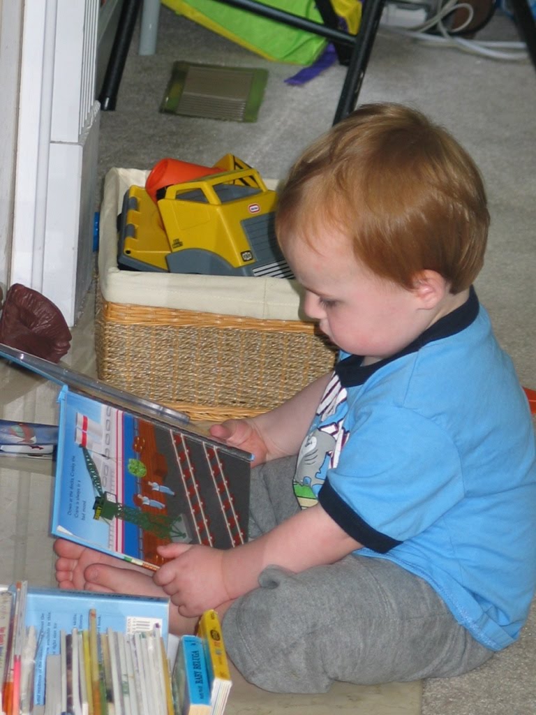 a baby boy reading books