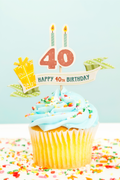 a cupcake with a topper saying, "Happy 40th Birthday" 
