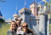 a family posing for a picture in front of Cinderella's castle at Disney World