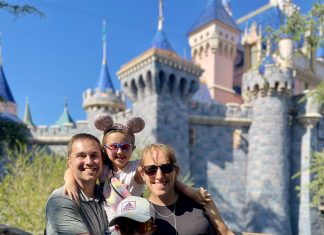 a family posing for a picture in front of Cinderella's castle at Disney World