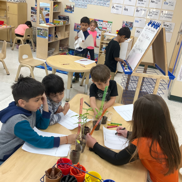 preschool students working at various stations in their Kiddie Academy. classroom