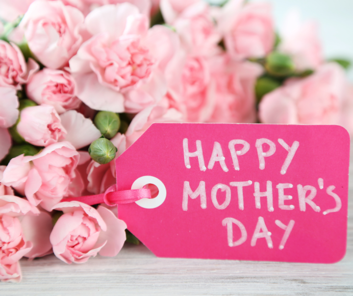 a close up of a bouquet of pink roses with a fuchsia tag saying, "Happy Mother's Day"