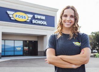 Regan Smith, USA Olympian and Foss Swim School former student standing in front of Foss Swim School