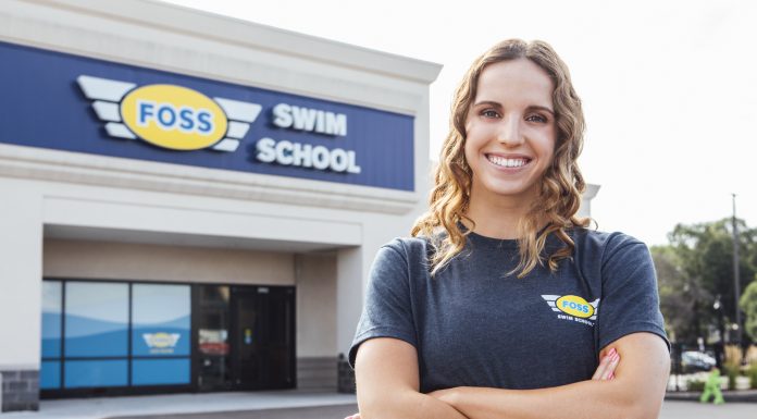 Regan Smith, USA Olympian and Foss Swim School former student standing in front of Foss Swim School