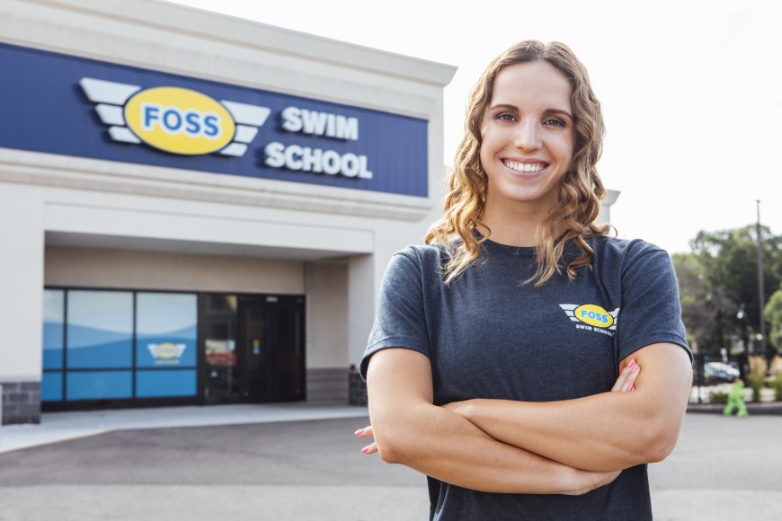 Regan Smith, USA Olympian and Foss Swim School former student standing in front of Foss Swim School