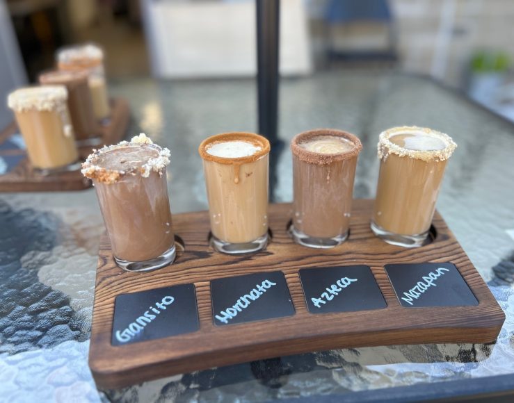 a close up of a tray with a flight of four coffees from Brew and Bites Cafe in St. Louis