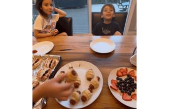 a plate full of Halloween treats sitting in front of two kids at the counter