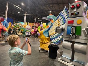 Taking pictures of his favorite float pieces at Mardi Gras World.