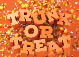 The words, Trunk or Treat in orange letters on a candy corn confetti background