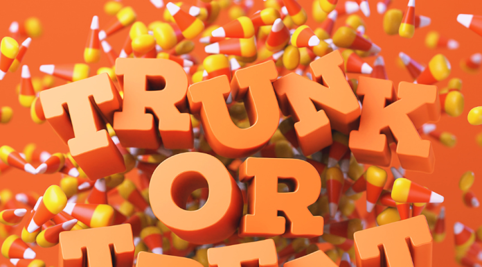 The words, Trunk or Treat in orange letters on a candy corn confetti background