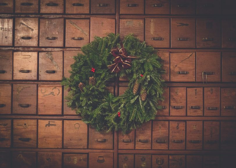 a wreath hanging in a mausoleum representing grief during the holidays